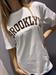  T-Shirt bianca scritta brooklyn marrone